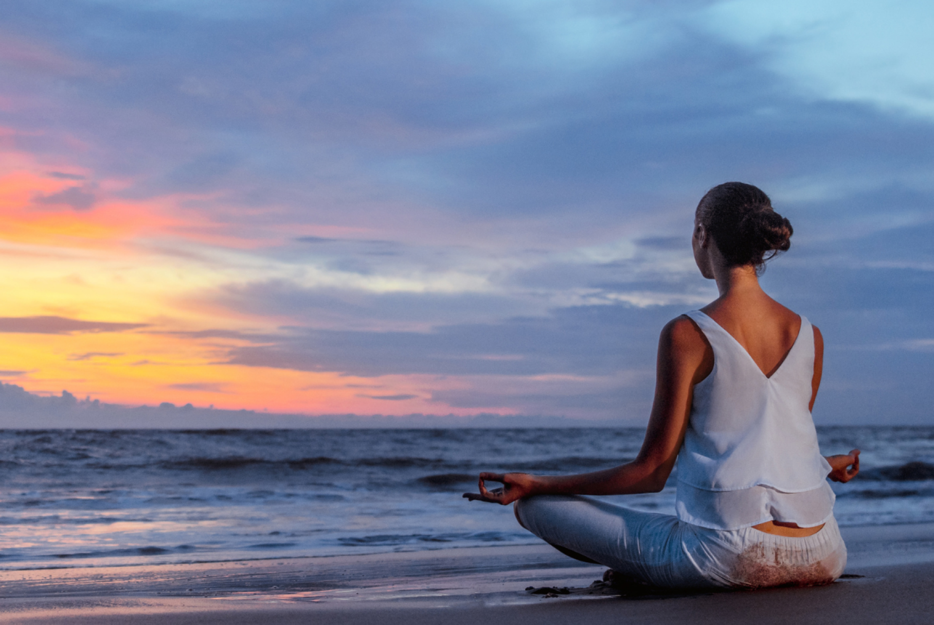 Woman Meditating on the beach